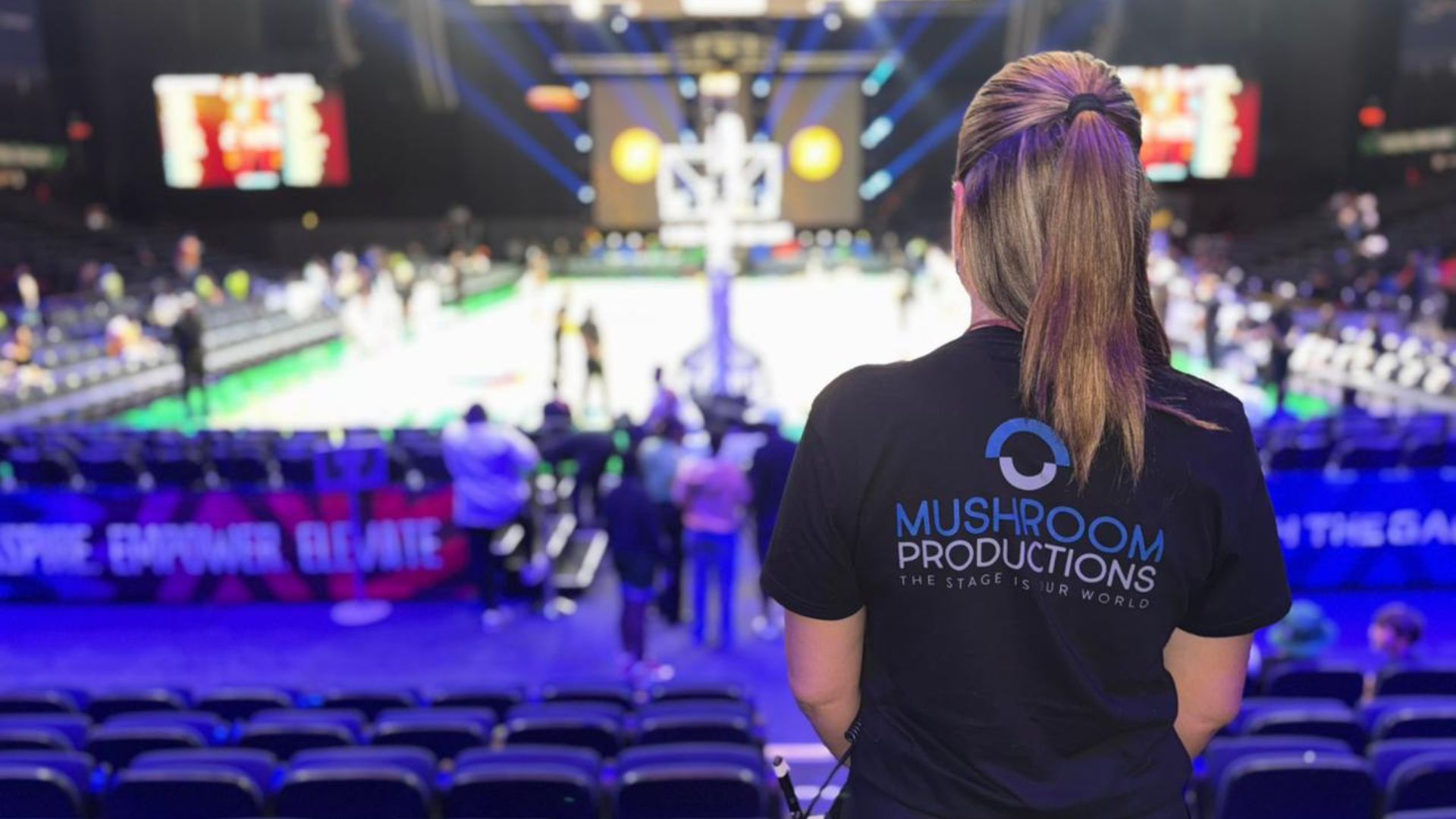Mushroom Productions crew member overseeing sports entertainment event production at the Basketball Africa League from the stands