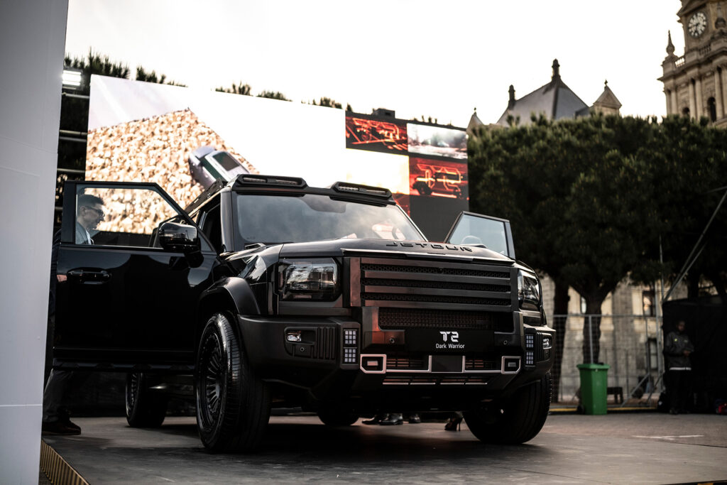 Cinematic automotive reveal staging with dramatic lighting and LED walls