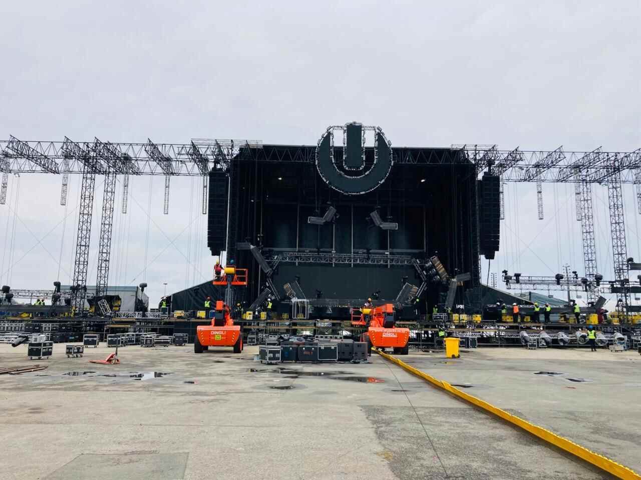 Festival stage under construction with truss rigging and crew