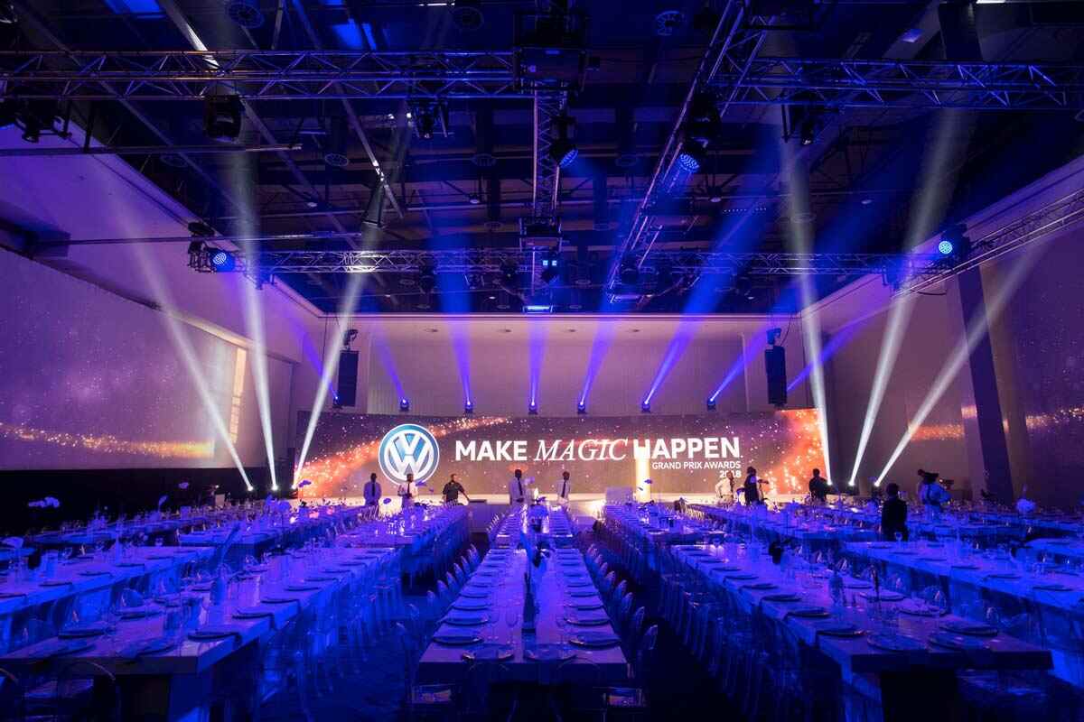 Volkswagen gala dinner venue with banquet tables, stage lighting and corporate awards production